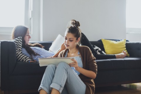 Caucasian women studying in living room