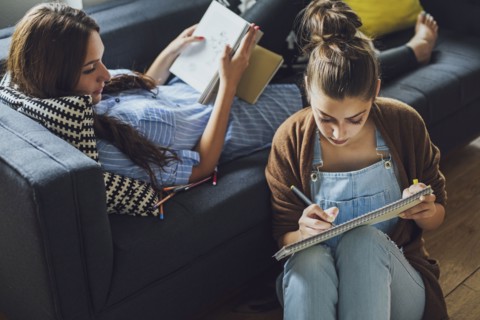 Caucasian women studying in living room