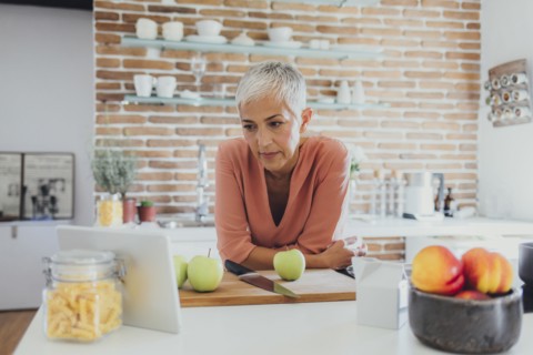 Older Caucasian woman cooking in kitchen