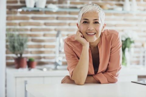 Older Caucasian woman smiling in kitchen