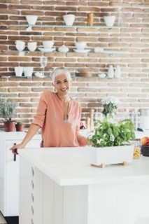 Older Caucasian woman smiling in kitchen