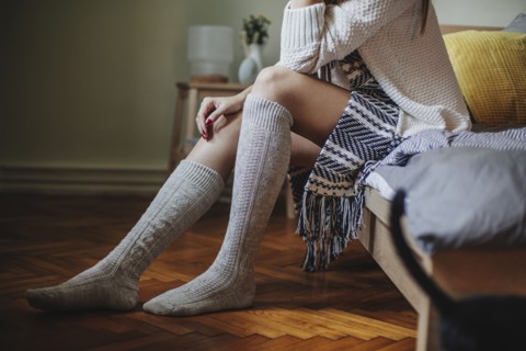 Caucasian woman sitting on bed