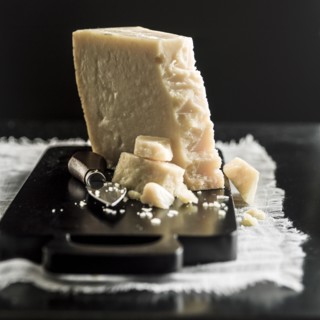 Parmesan cheese crumbles on cutting board
