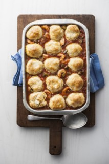 Dumplings gumbo in pan on cutting board