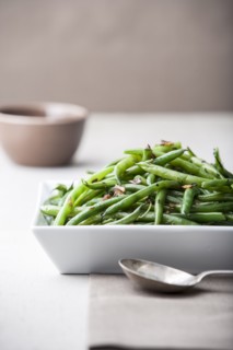 Pile of roasted green beans with spoon