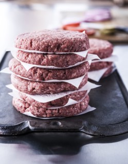 Stack of raw lean ground beef hamburger patties