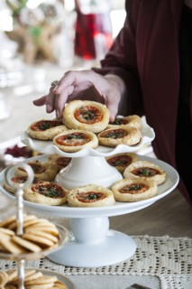Hand holding holiday tart on tray
