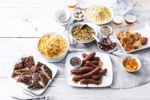 Plates of food and beer on wooden table