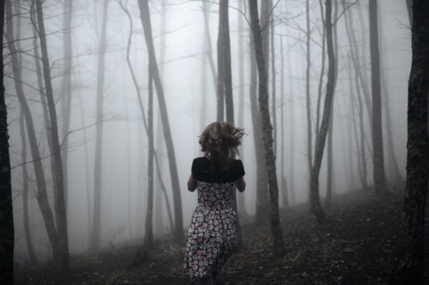 Caucasian woman running in forest
