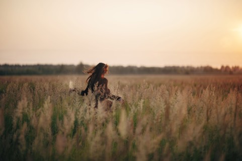 Caucasian woman walking in rural field