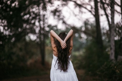 Caucasian woman standing in forest