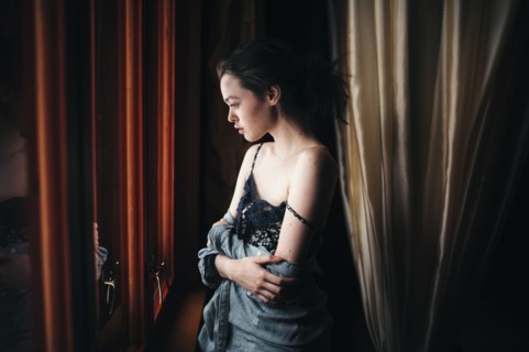 Caucasian woman looking out window