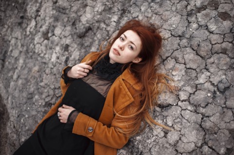 Caucasian woman laying on rock formation
