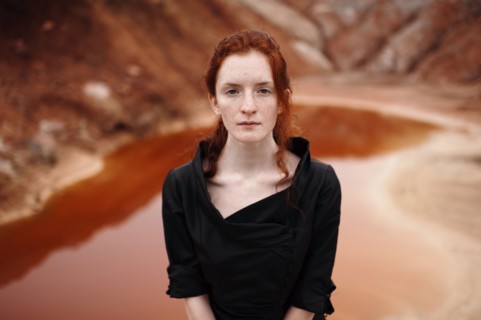 Caucasian woman standing near remote pool