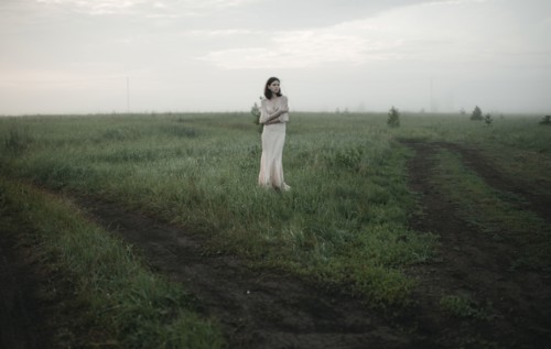 Caucasian woman standing in remote field