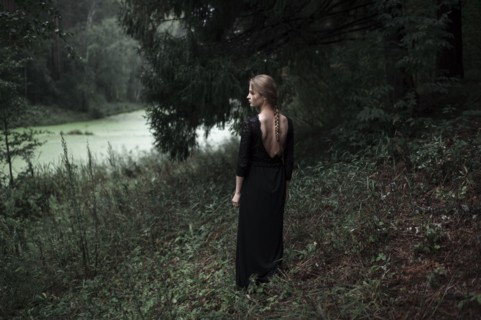 Caucasian woman standing on forest hillside