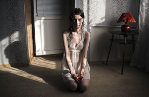 Caucasian woman kneeling on floor