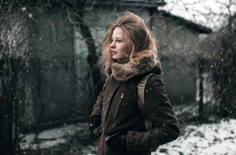 Caucasian woman walking in snow
