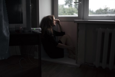 Caucasian woman sitting near door