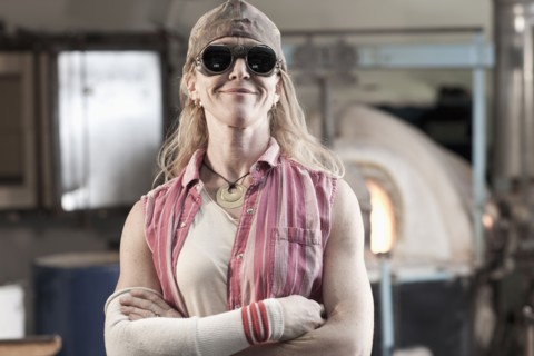 Caucasian woman in glass blowing studio