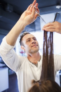 Hairdresser cutting hair in salon