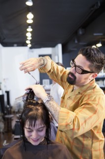 Hairdresser cutting hair in salon