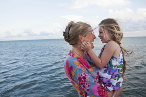 Caucasian mother and daughter enjoying the beach