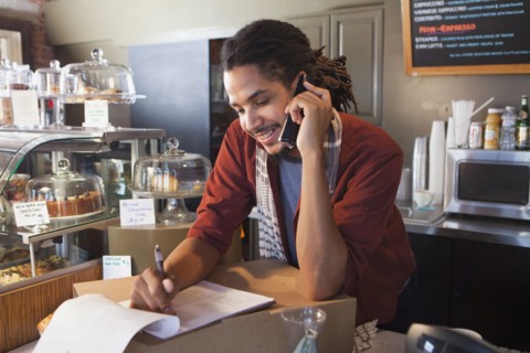 Mixed race man working in coffee shop
