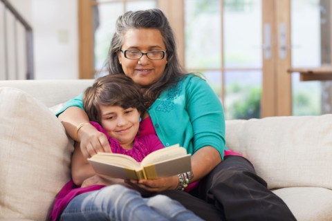 Mother and daughter reading book together
