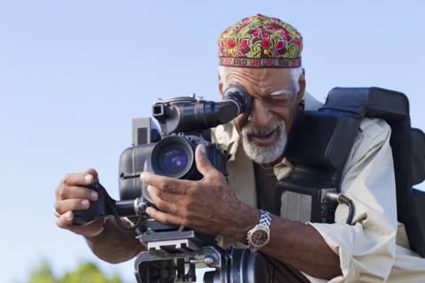 African American man using film camera
