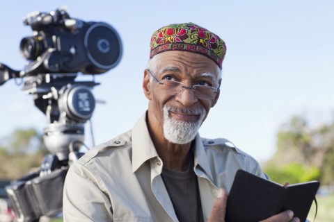 African American director near film camera