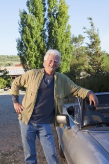 Caucasian man leaning on convertible