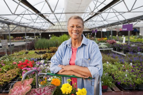 Mixed race woman working in plant nursery