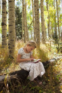 Caucasian girl using digital tablet in woods