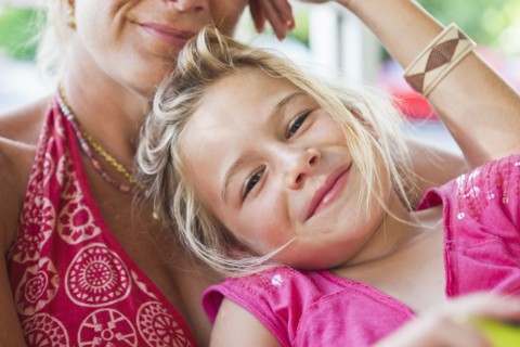 Caucasian mother and daughter sitting together