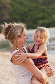 Caucasian mother and daughter enjoying the beach