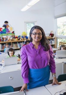 Indian teacher standing in classroom