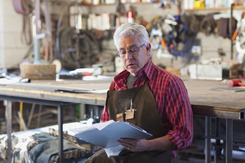Hispanic craftsman working in shop