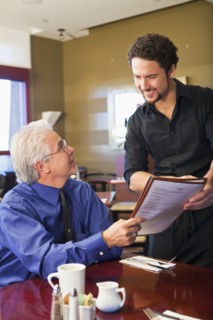 Businessman ordering food in cafe