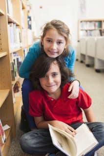 Caucasian students smiling in library