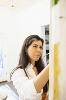 Hispanic artist working in studio