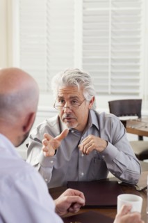 Businessmen talking in cafe