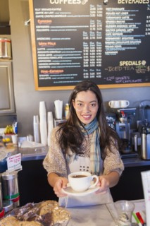Mixed race woman working in coffee shop