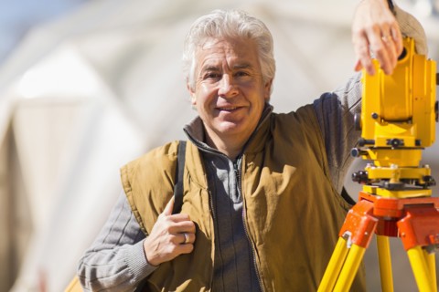 Hispanic surveyor working outdoors