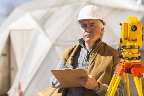 Hispanic surveyor working outdoors