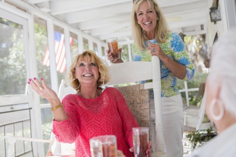 Caucasian women talking on porch
