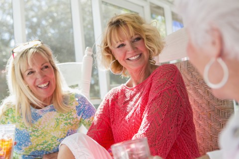 Caucasian women talking on porch