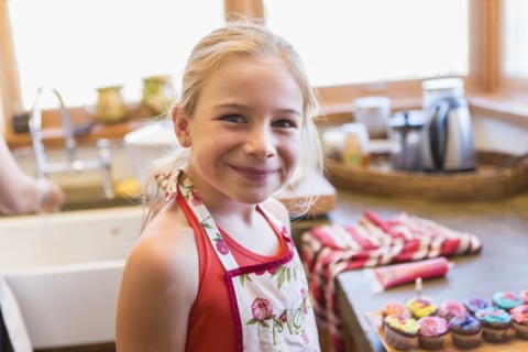 Caucasian girl smiling in kitchen