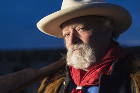 Caucasian man holding gun outdoors