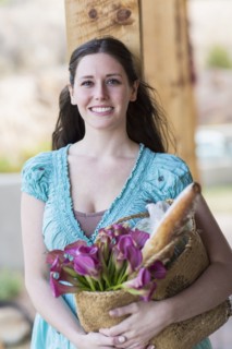 Caucasian woman holding basket of groceries